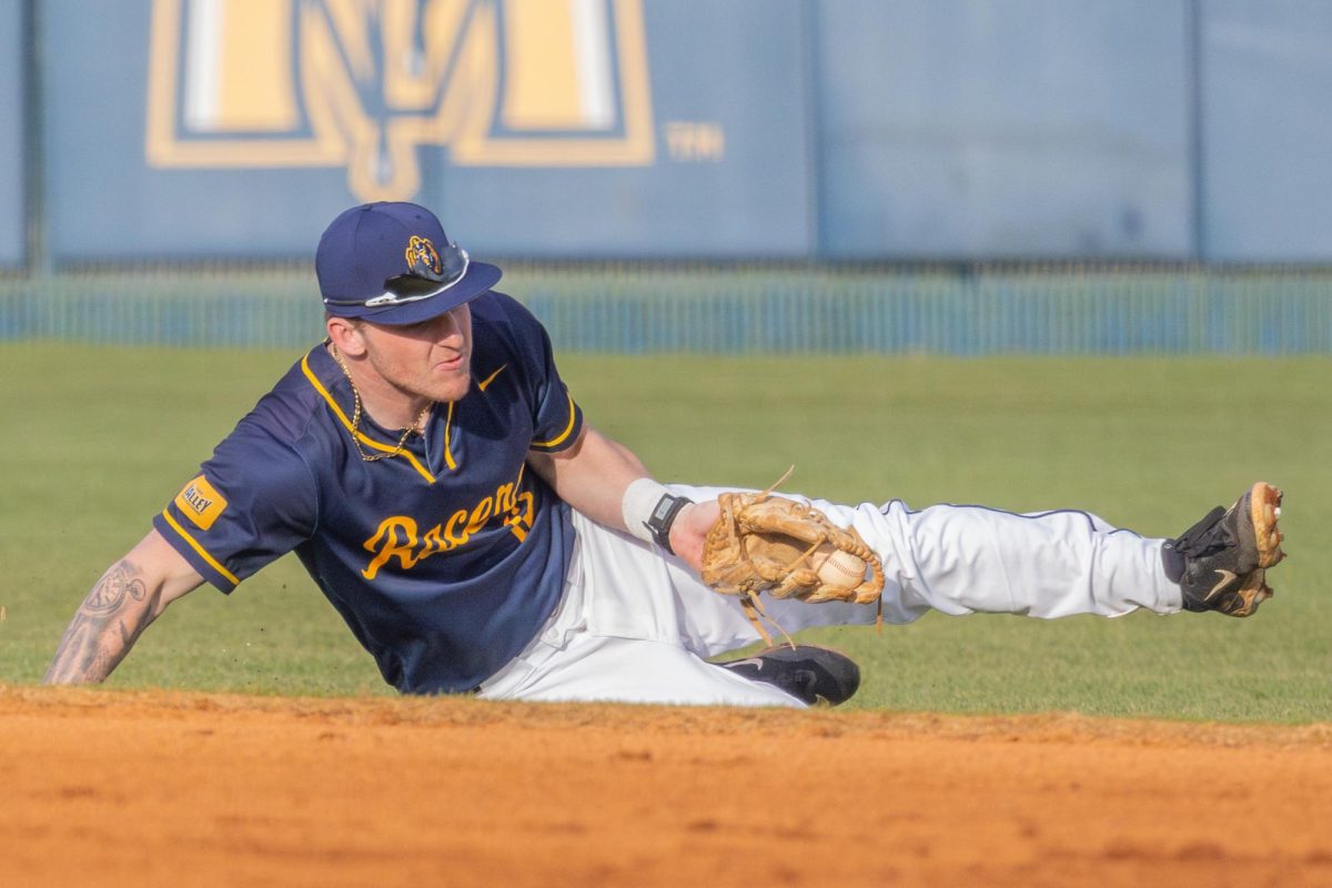 Redshirt sophomore infielder Dom Decker makes a sliding catch for an out.