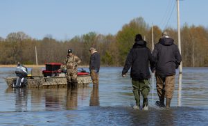 Phil and Phyllis Panici walk through the floodwaters to their boat.