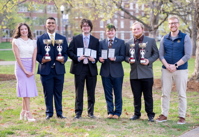 Anya Moyers, assistant director, Samuel Harless, Caleb McCurren, Zack Benz, Samuel Miller and Ryan Goke celebrate Pi Kappa Delta awards (Not pictured: Jillian Rosa, assistant director).