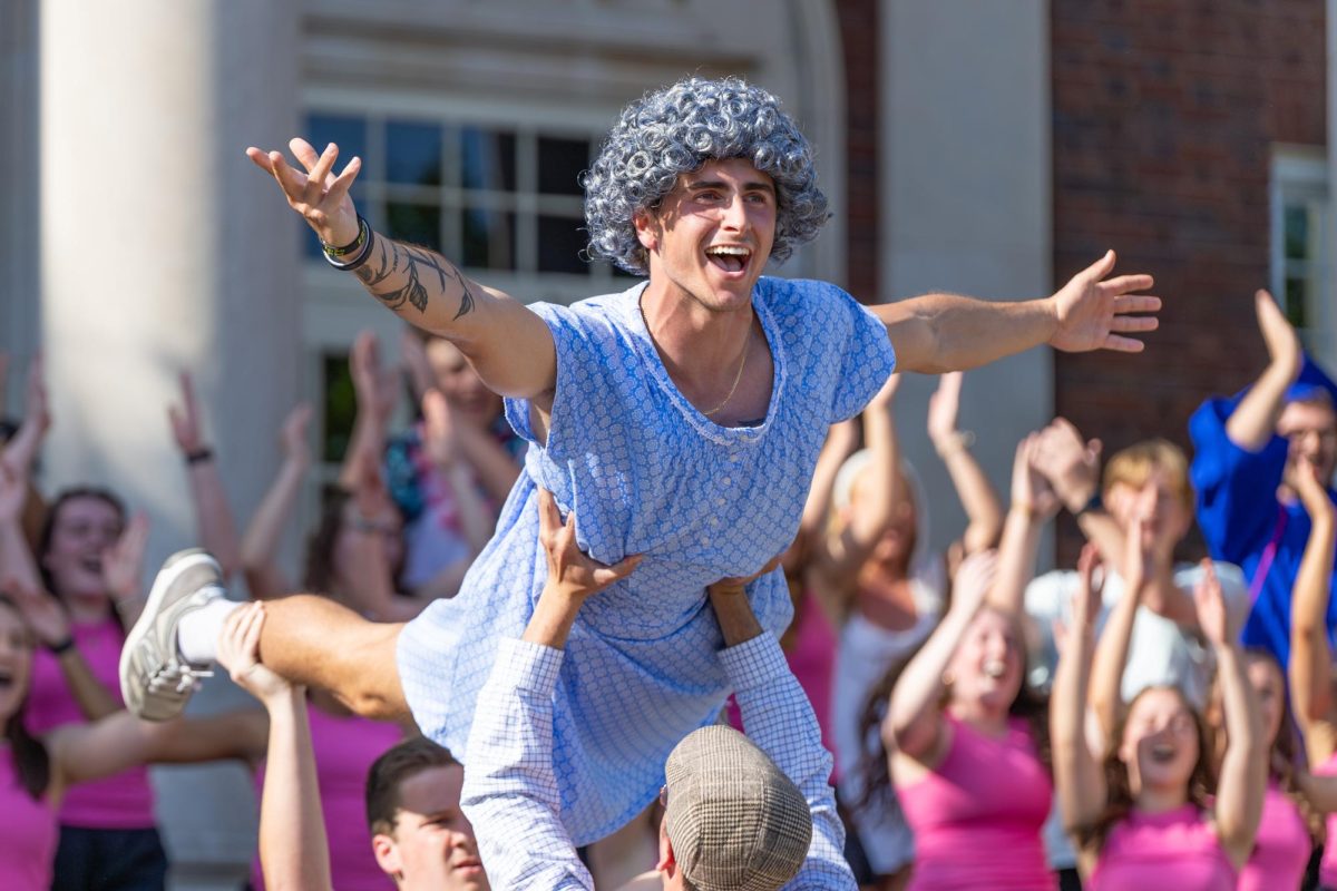 A member of BCM is lifted into the air during their performance.