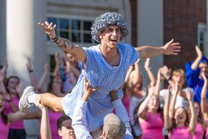 A member of BCM is lifted into the air during their performance. 