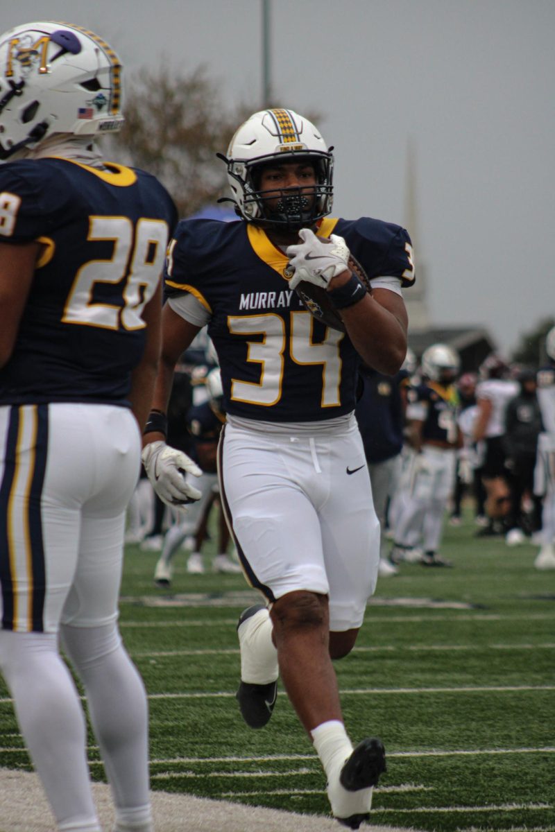 Freshman running back Caleb Ford warms up before the game. 