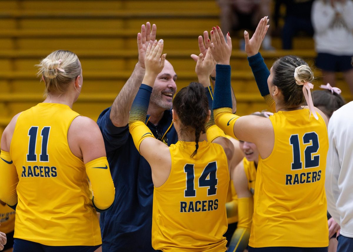 Head Coach David Schwepker high-fiving his team.