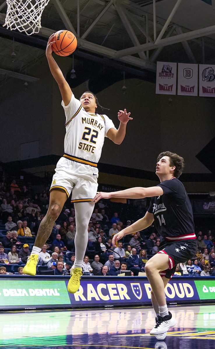 Senior Guard Javon Jackson making a layup against an UIC player.