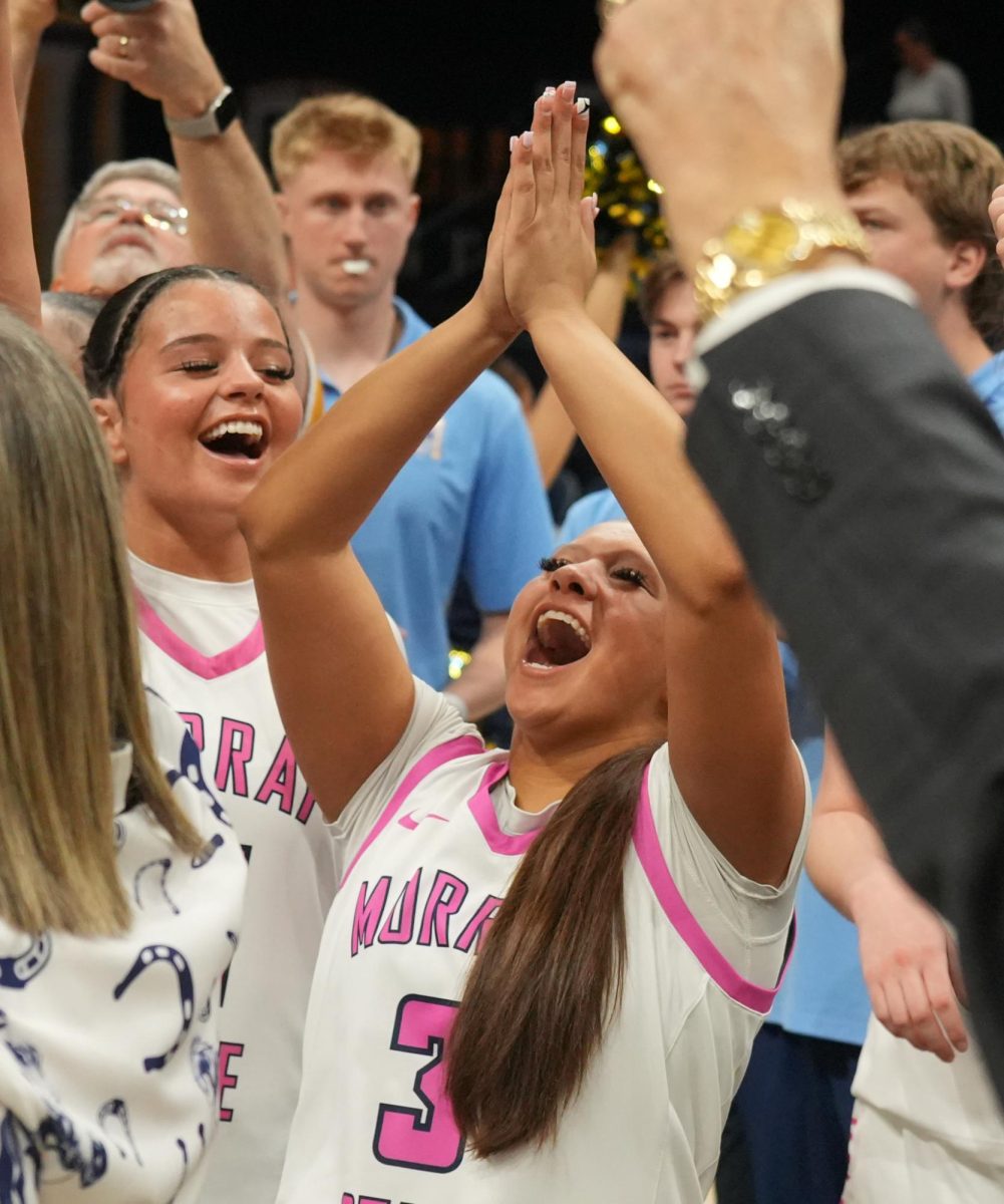 Senior guard Briley Pena celebrating with her fellow teammates after winning a share of the MVC title.