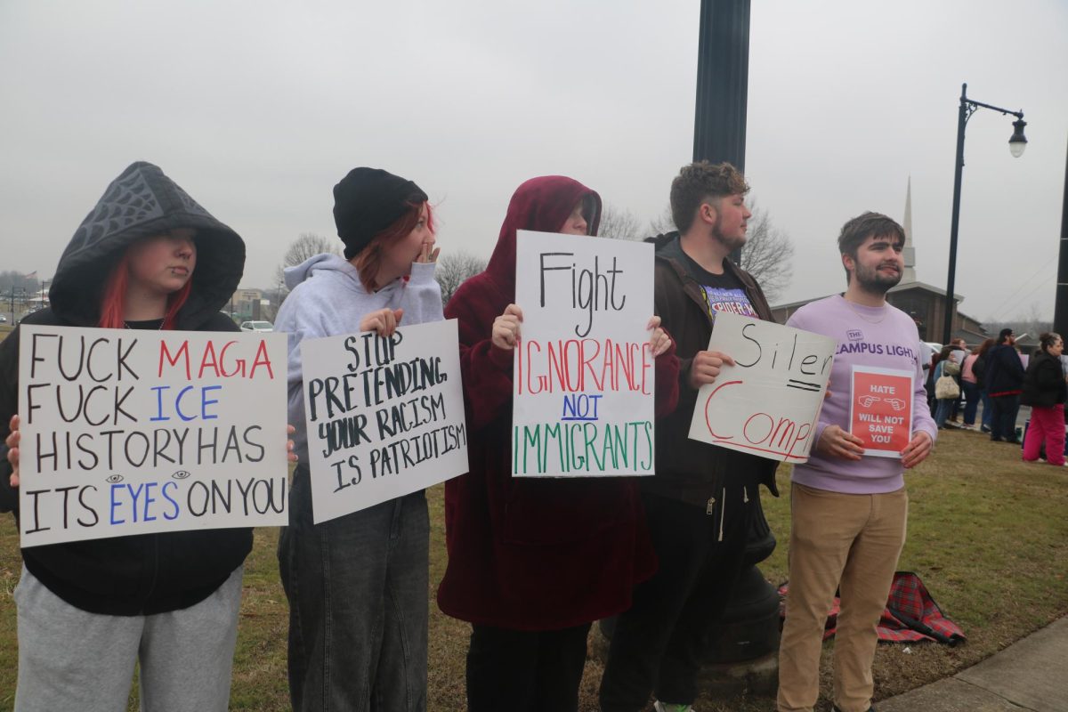 Protesters with their signs lined up on the corner of 121 North and 12 Street.