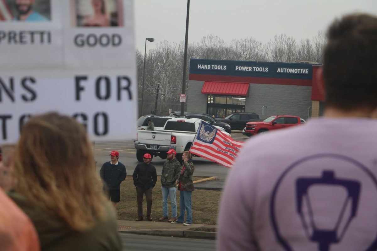 Trump supporters, and former Murray State Judicial Board Justice and Republicans President Coleson Thomas, with an altered historical American flag, labeled with "Natives beware of Foreign Influence