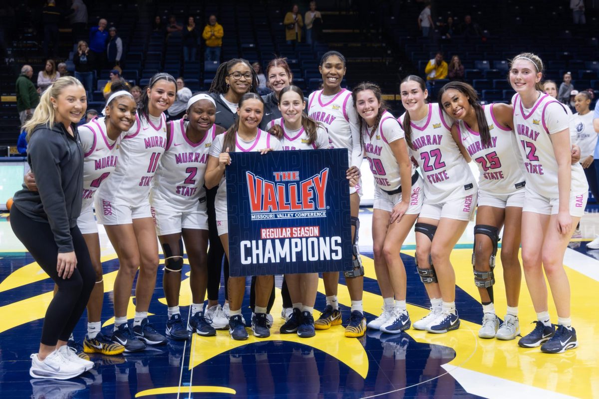 The team poses for a picture with the MVC regular season champions sign. 
