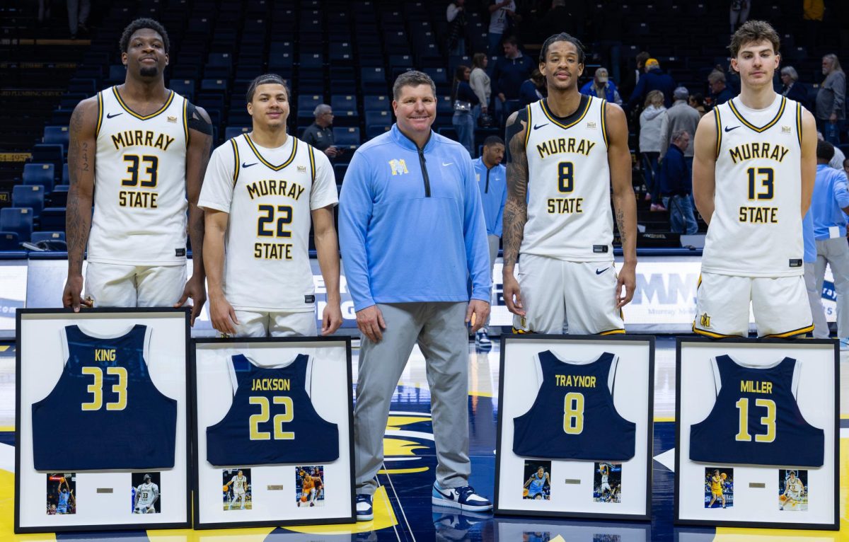 Head Coach Ryan Miller poses for a photo with his four senior players. 