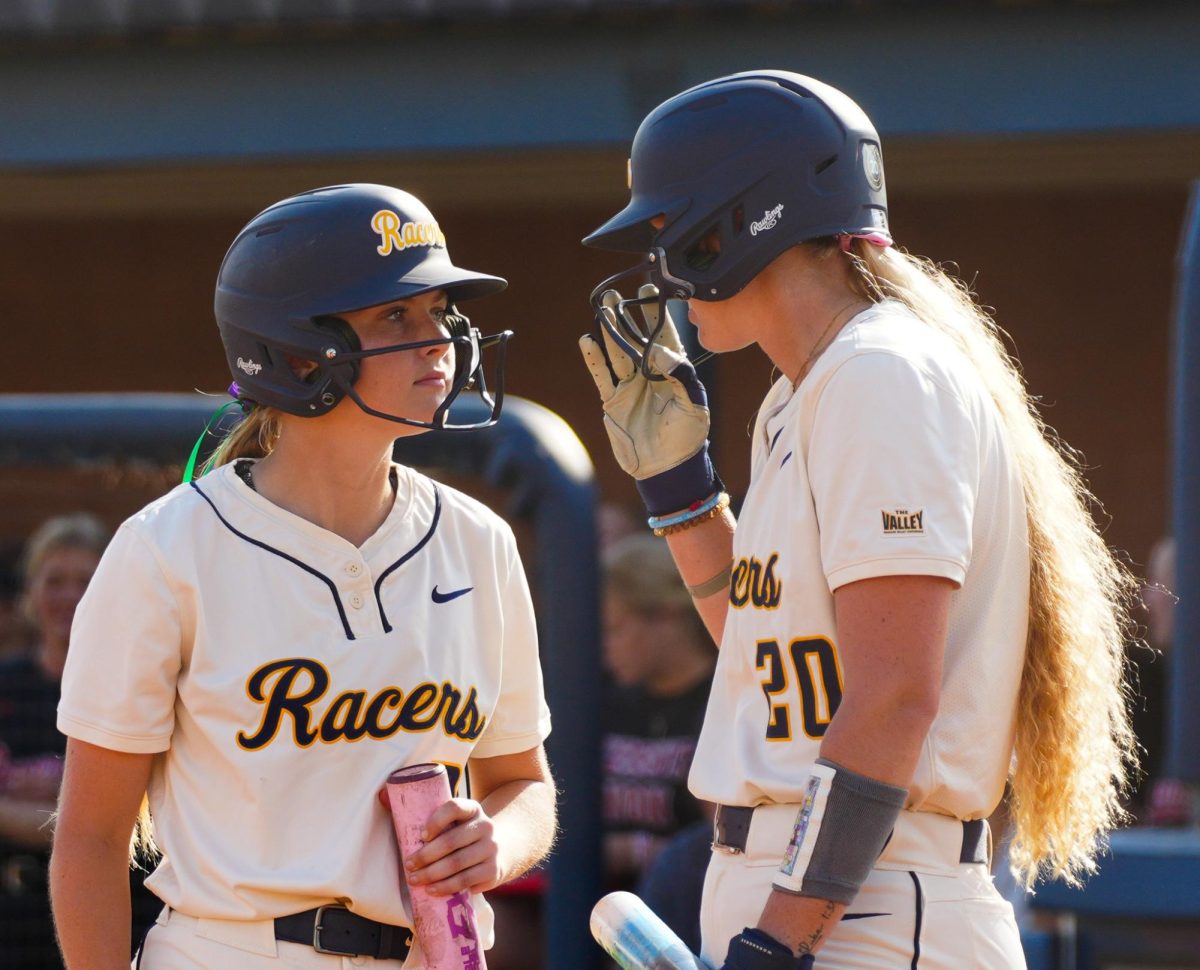Sophomore Outfield Kynadee Warner and senior Infield Ailey Schyck discussing Austin Peay's pitcher. 
