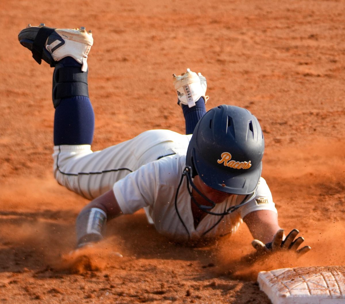 Sophomore Utility Katy Huels sliding into 3rd base.