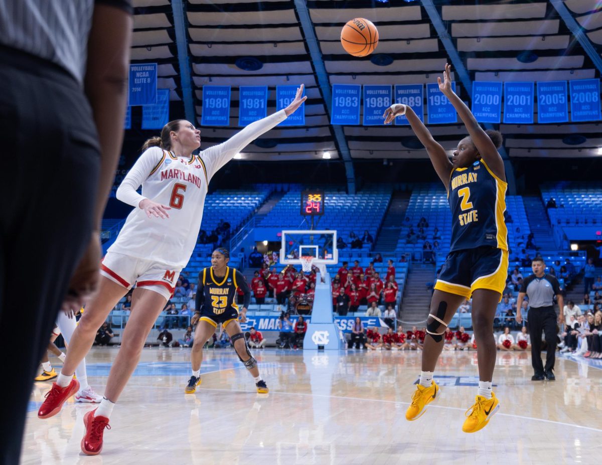 Haven Ford pulling up for a mid-range jump shot over a Maryland defender.