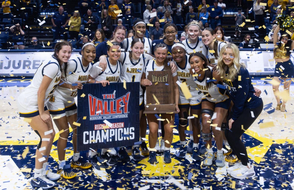 The team celebrates after being awarded the regular season championship trophy.