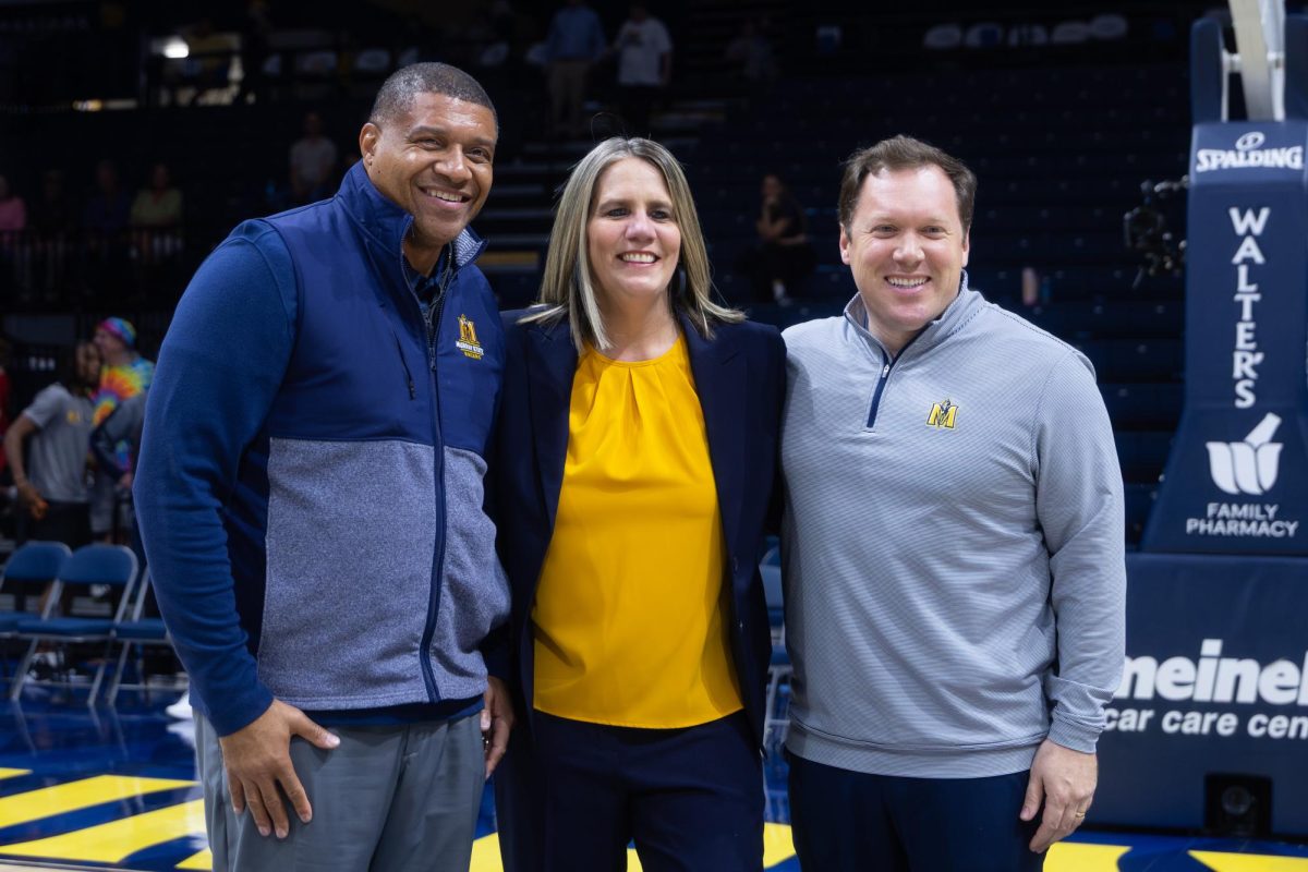 Dr. Ron Patterson, Rechelle Turner and Nico Yantko pose for a picture after women's basketball won their second-straight regular season title.