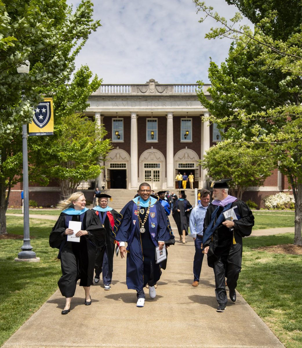 From left: Melissa Bell with council on post-secondary education, President Ron Patterson and Robbie Fitch, Board of Regents chairman leave the inauguration and walk toward the reception at Pogue Library. 