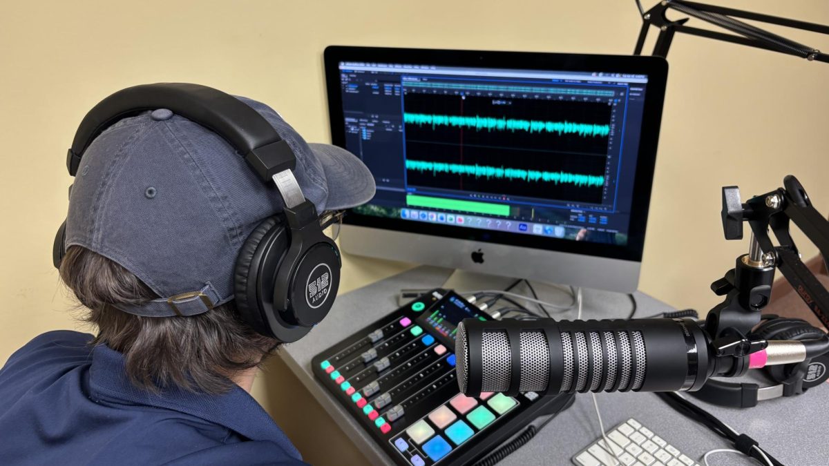 Sports editor Riley Staton edits an audio file for The Shoes Up Report. 