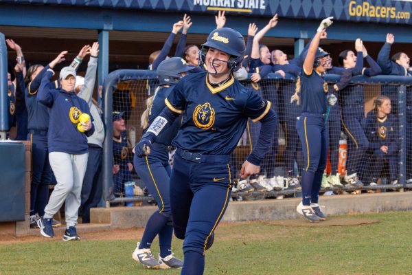 Freshman catcher Allie Waldron smiles while crossing home plate.