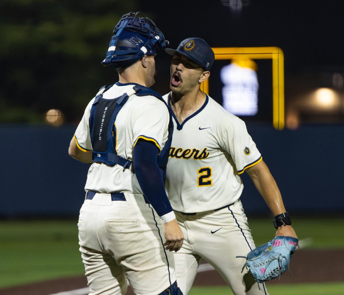 Nic Schutte and Parker Airhart celebrate after Schutte throws a complete game in the Racers' win.